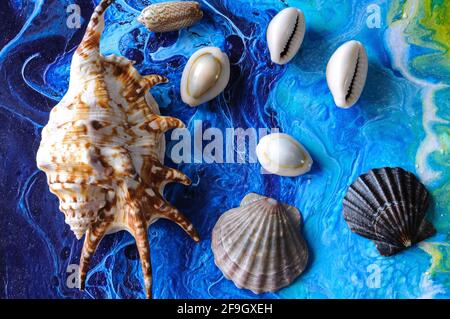 Seashells on a bright background. Acrylic Pouring Stock Photo