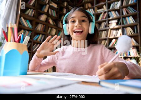 Web cam view of smiling happy indian schoolgirl on online learning classes. Stock Photo
