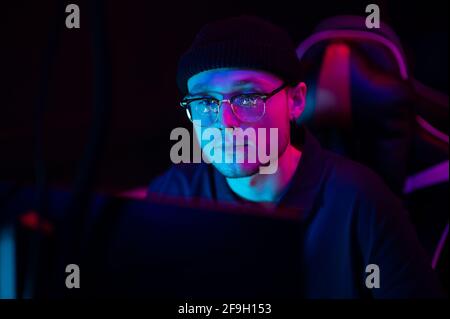 Close-up of the face of a professional video game player at an esports tournament. A cyberathlete wearing headphones and a headset Stock Photo