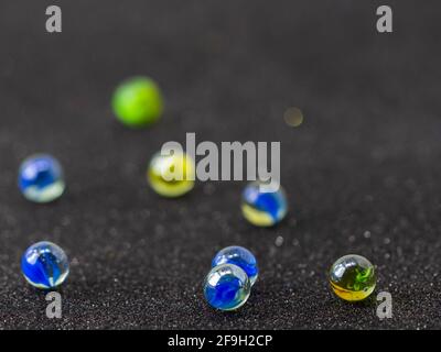 scattered colored glass marbles on black background Stock Photo