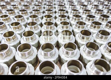 many metal pipe couplings in a pipe factory Stock Photo