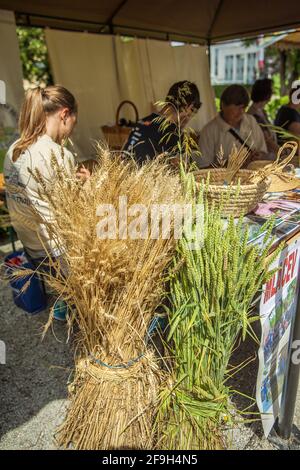 DOMZALE, SLOVENIA - Jun 21, 2019: Stands offering beautiful handmade straw products on summer festival Stock Photo