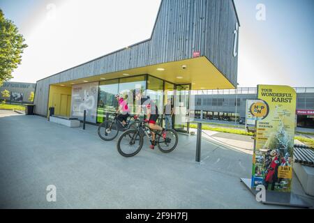 POSTOJNA, SLOVENIA - Jun 20, 2019: Young couple starting cycling towards destination, the're in front of tourism info centre Stock Photo