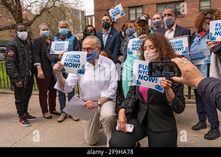 NEW YORK, NY – APRIL 18: Chuck Schumer, members of New York's congressional delegation and NYCHA residents pose for pictures before a press conference calling to increase NYCHA funding on April 18, 2021 in New York City.   In a press conference, held at Harlem's George Washington Houses, Senate Majority Leader Chuck Schumer and members of New York's congressional delegation calling for New York's dilapidated public housing funding in President Joe Biden's $2 trillion jobs and infrastructure plan to increase from $40 billion to $80 billion. Credit: Ron Adar/Alamy Live News Stock Photo