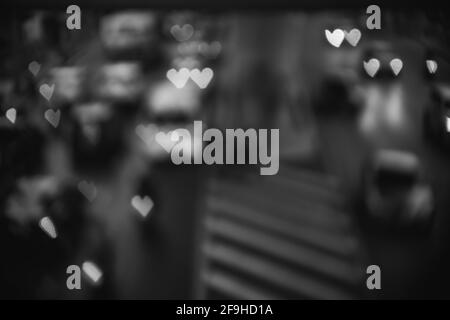 Abstract blurred traffic jam road with heart shaped lights in black and white Stock Photo