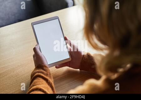 High angle closeup of contemporary man holding digital tablet with blank white screen while using internet or working remotely, copy space Stock Photo