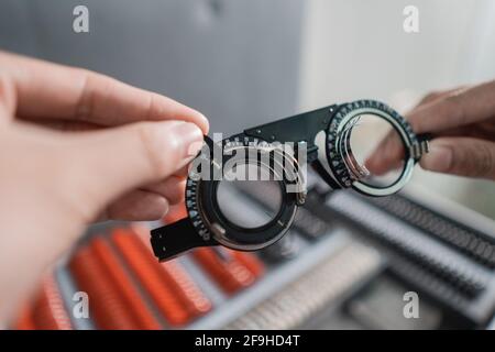 an adjustable axis trial frame is being held by a doctor Stock Photo