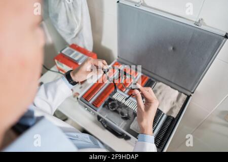 an adjustable axis trial frame is being held by a doctor Stock Photo