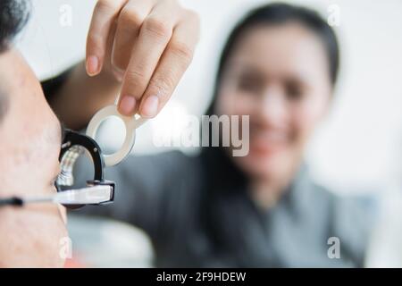 a female ophthalmologist on a trial frame when with the patient Stock Photo