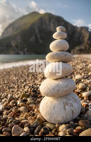 Balance stones on the beach at sunrise Stock Photo