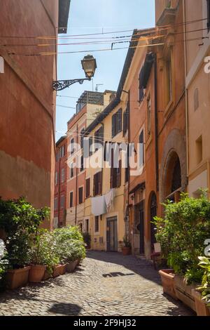 Cozy narrow street with drying laundry in Trastevere district, Rome, Italy Stock Photo