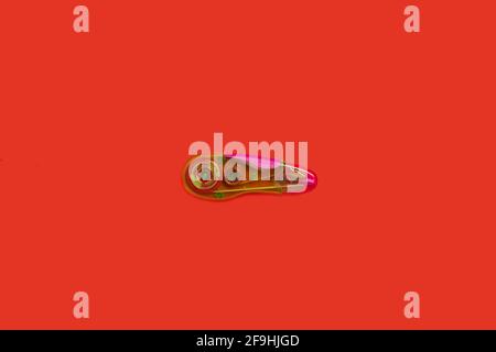plastic tape corrector on a red background Stock Photo
