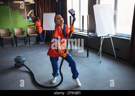 Janitorial staff in the modern office during the clean-up Stock Photo