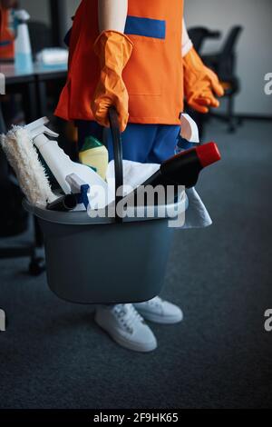 Janitor with janitorial supplies standing on the carpet flooring Stock Photo