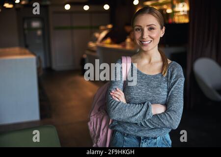 Joyous woman posing for the camera in an office cafeteria Stock Photo