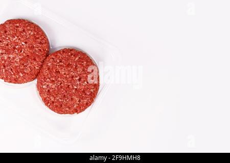Raw round burger patties in package on white background with copy space Stock Photo