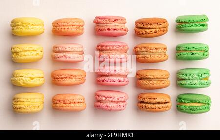 Sweet and colorful French macaroons in row, top view, flat lay Stock Photo