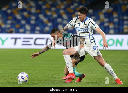 Naples, Italy. 18th Apr, 2021. Napoli's Italian forward Matteo Politano fights for the ball with Inter Milan's Italian defender Alessandro Bastoni during the Serie A football match SSC Napoli vs FC Internazionale Milano. Napoli and Inter drew 1-1. Credit: Independent Photo Agency/Alamy Live News Stock Photo