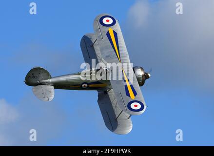 Vintage Gloster Gladiator aircraft in flight with cloud and blue sky background Stock Photo