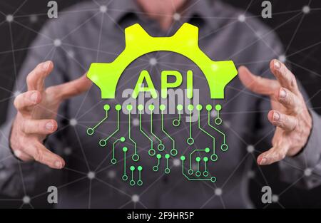 Api concept between hands of a man in background Stock Photo