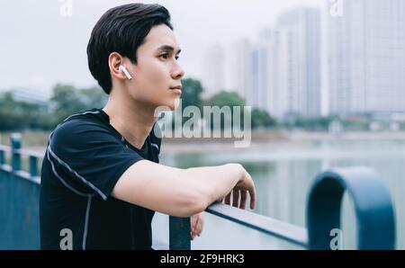 Young Asian man is resting after the practice session Stock Photo