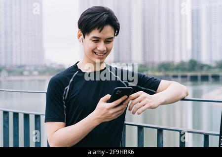 Young Asian man is resting after the practice session Stock Photo