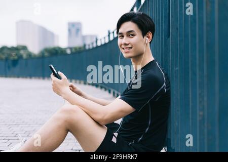 Young Asian man is resting after the practice session Stock Photo