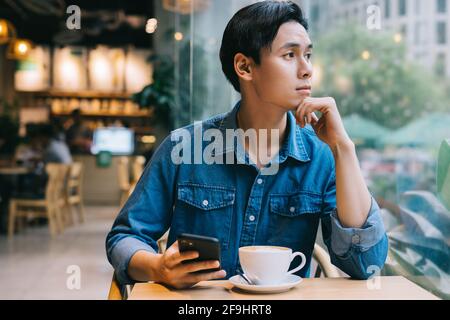 Asian man working at cafe on weekend Stock Photo