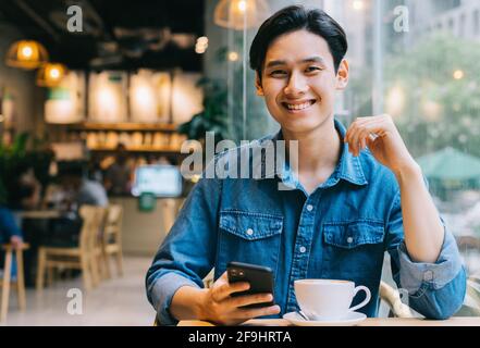 Asian man working at cafe on weekend Stock Photo