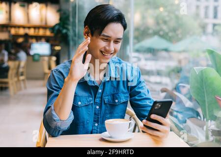 Asian man working at cafe on weekend Stock Photo