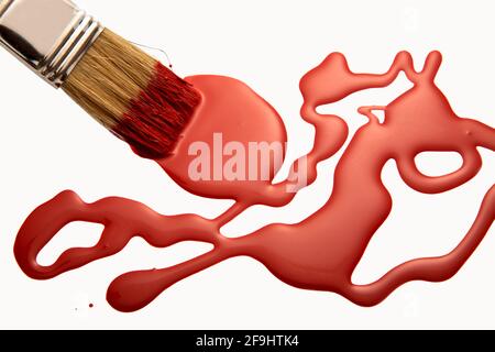red paint with brush on white background Stock Photo