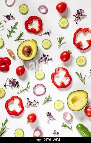 Creative layout of tomatoes, cucumbers, bell peppers, avocados and salads. flat lay. Food concept. place for your text. Stock Photo