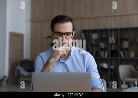 Caucasian man work online on laptop consulting client Stock Photo