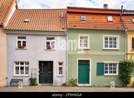 Leaning roofs on a renovated semi detached house with historic windows and doors in the old town of Wismar. Stock Photo