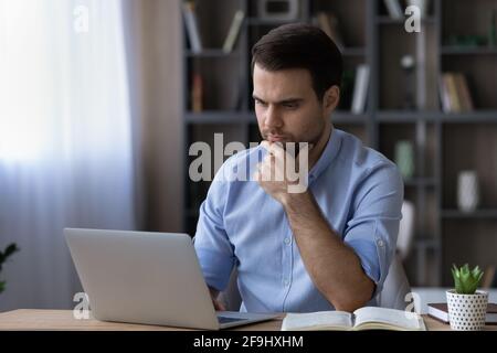 Thoughtful man use computer gadget making decision Stock Photo