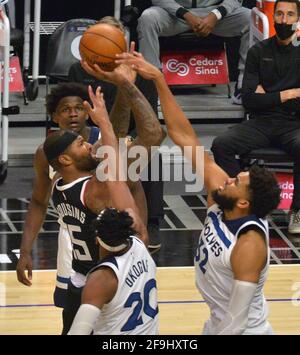 Los Angeles, Unites States. 18th Apr, 2021. Los Angeles Clippers' center Demarcus Cousins (15) shoots over Minnesota Timberwolves' forward Josh Okogie (20) and center Kari-Anthony Towns (32) during the second half of their NBA game at Staples Center in Los Angeles on Sunday, April 18, 2021. The Clippers defeated the Timberwolves 124-105. Photo by Jim Ruymen/UPI Credit: UPI/Alamy Live News Stock Photo