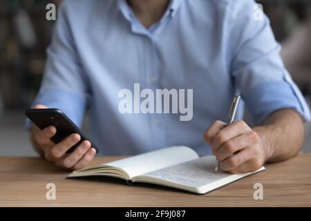 Close up of man handwrite using modern smartphone Stock Photo