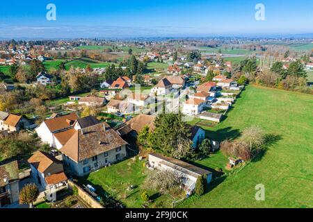 Aerial perspective of Beautiful Sunset featuring residential properties in the small town of Saint-André-le-Gaz, which is surrounded by green trees Stock Photo