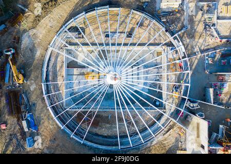 top down view of white metal frame in round shape, featuring structure under construction in Faverges, France Stock Photo