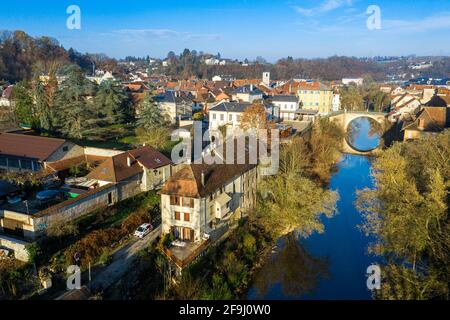 Aerial shot of a small town under the vast blue sky taken using a drone. Stock Photo