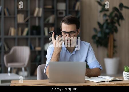 Young Caucasian businessman consult client over cellphone call Stock Photo