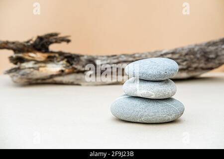 Pile of gray stones on background of big log. Natural components concept. Place for text. Stock Photo