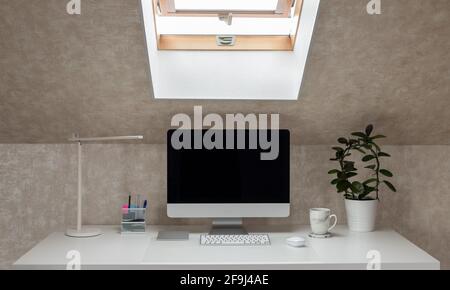 office desk with monitor, table lamp and coffee mug. working home. coffee break. horizontal image. selective focus Stock Photo