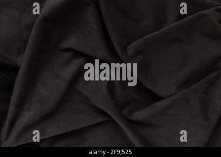 dark brown suede with folds on the surface. Natural texture background Stock Photo