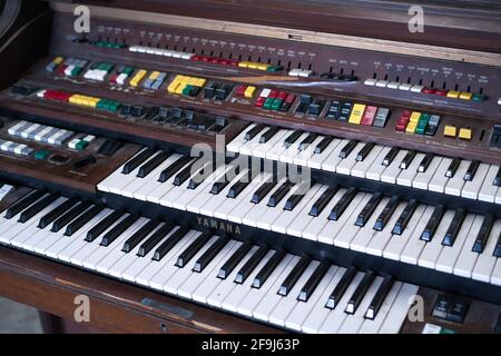 The Vintage Big Piano Keyboard. Many keys and buttons on a big old  church organ. Bangkok, Thailand in January 5, 2020. Stock Photo