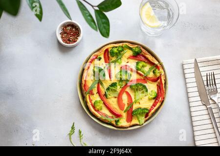 healthy broccoli and bell pepper omelette on gray concrete background. vegetarian breakfast. top view, horizontal image, copy space Stock Photo
