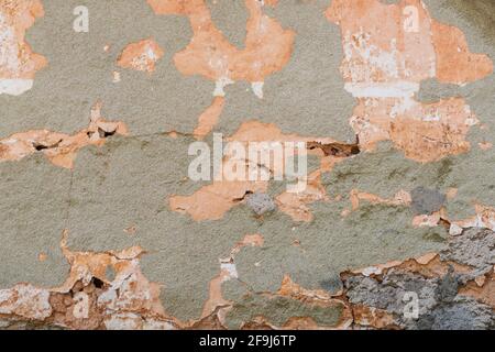 Old gray plastered wall with cracked paint. Background, texture. Stock Photo