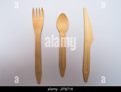 wooden disposable knife fork and spoon  ,eco freindly cutlery . On white background . Stock Photo