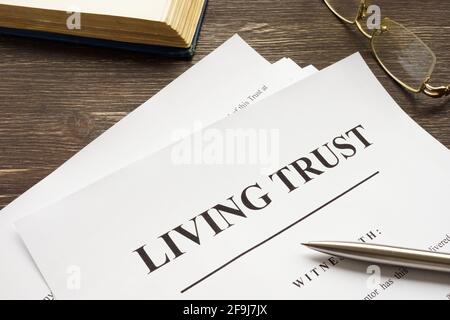 Living trust papers with pen and book. Stock Photo