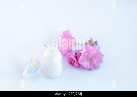 Bottles of essential oil with pink cherry blossoms Stock Photo by  ©MadeleineSteinbach 193115924